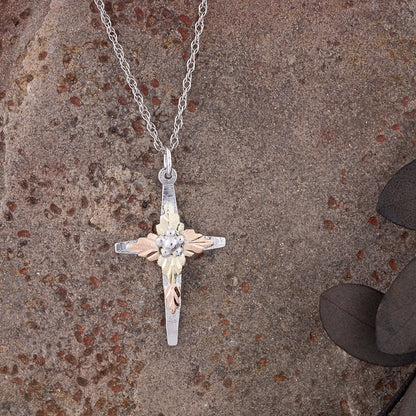 Sterling silver grape cluster center cross pendant by Landstrom's Black Hills Gold, styled view