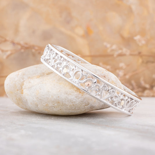 Sterling silver open pattern cuff bracelet by Landstrom's Black Hills Gold, styled view