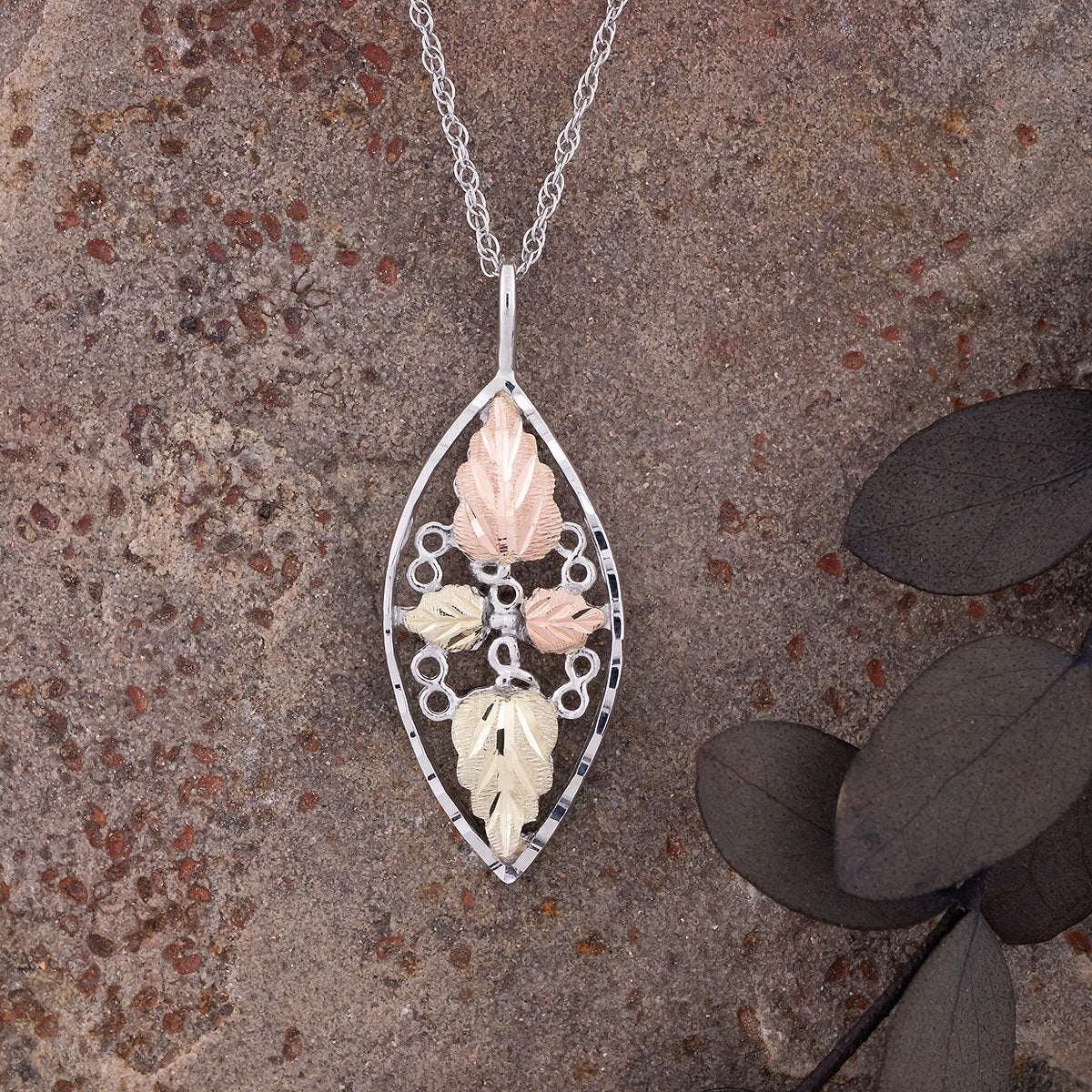 Sterling silver diamond cut marquise double leaf pendant by Landstrom's Black Hills Gold, styled view