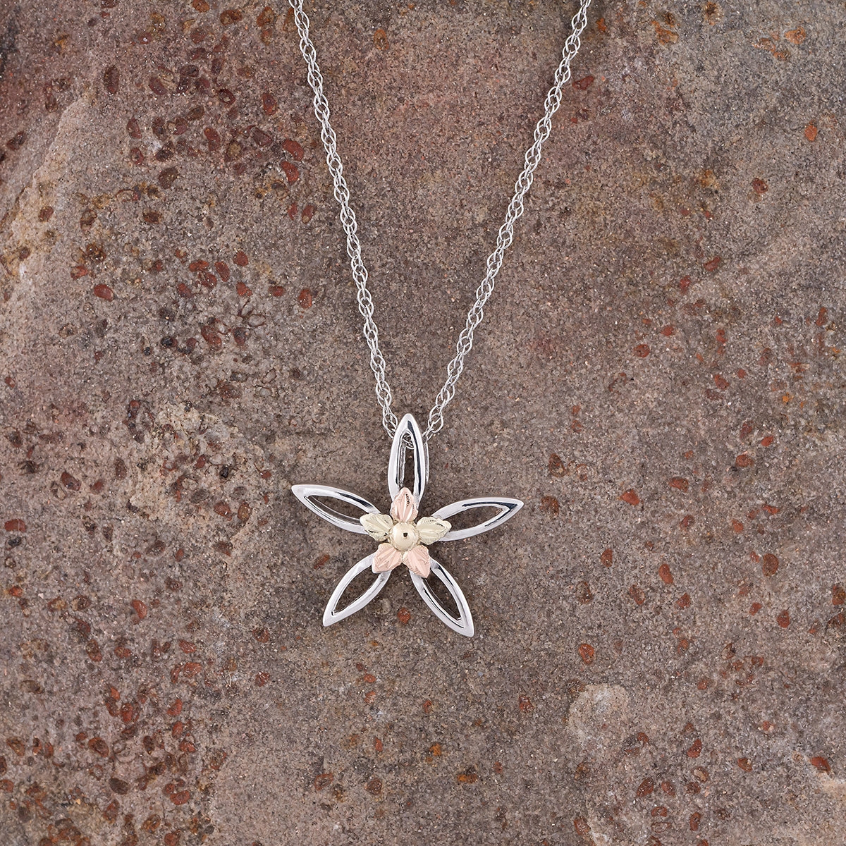 Sterling silver marquise petal flower pendant by Landstrom's Black Hills Gold, styled view