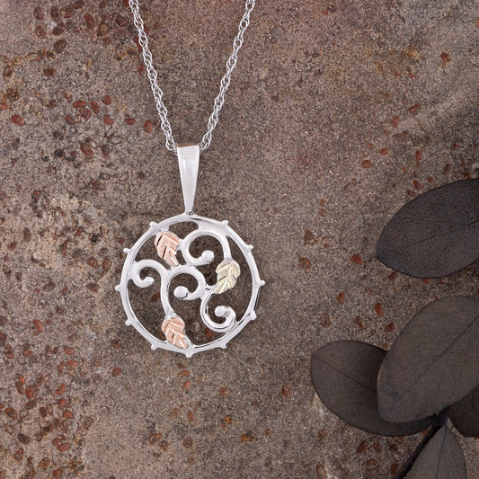 Sterling silver curled vine open circle pendant by Landstrom's Black Hills Gold, styled view