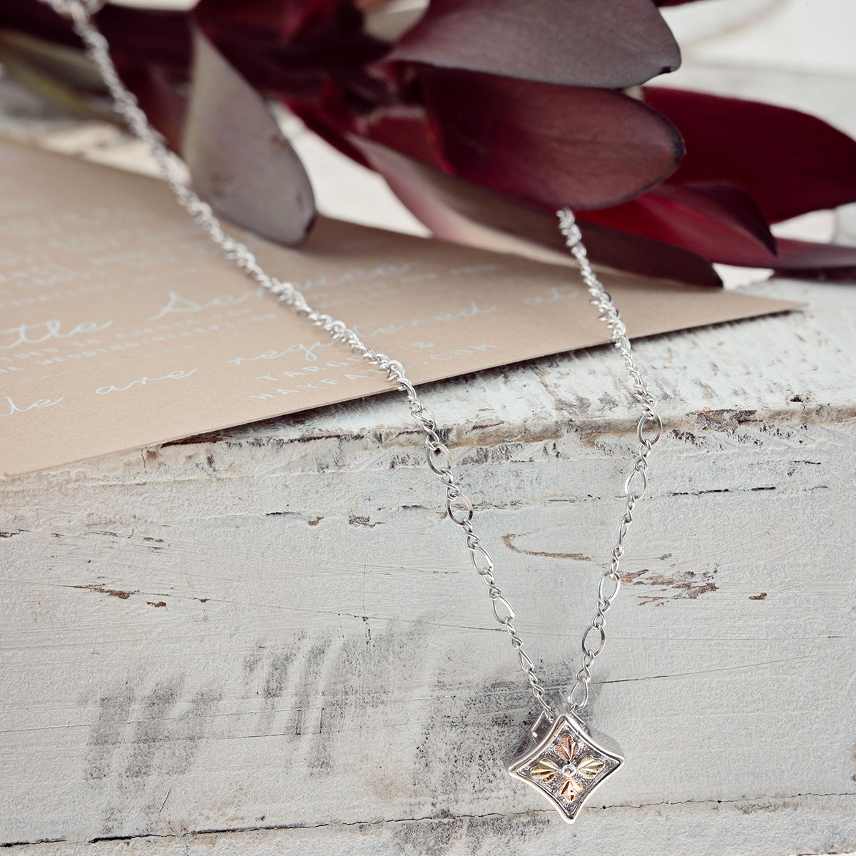 Sterling silver concave square pendant by Landstrom's Black Hills Gold, styled view