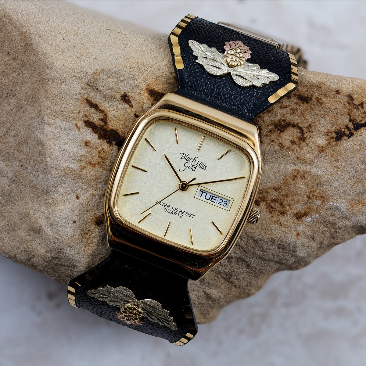 Men's quartz gold-tone stainless steel watch featuring square champagne dial and black powder coated band by Mt. Rushmore Black Hills Gold, styled view