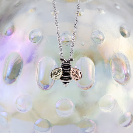 Sterling silver bee pendant by Landstrom's Black Hills Gold, styled view