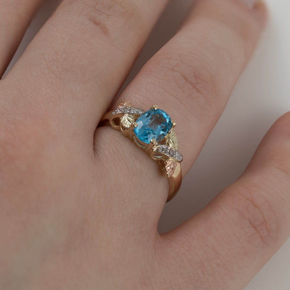 10K yellow gold oval blue topaz and diamond accent ring by Mt. Rushmore Black Hills Gold, side view